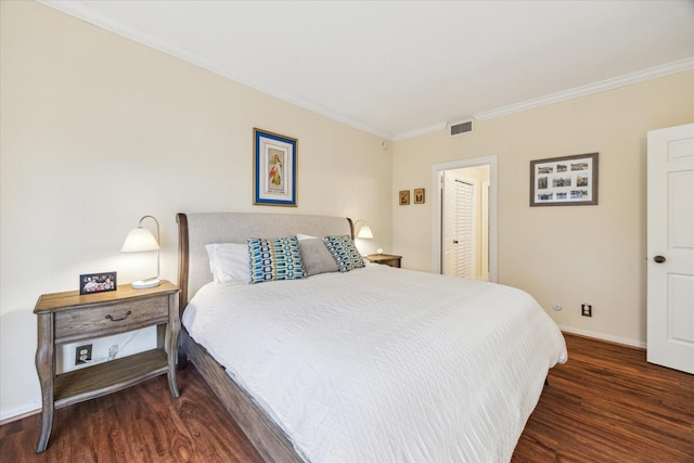 bedroom featuring dark wood-type flooring and ornamental molding