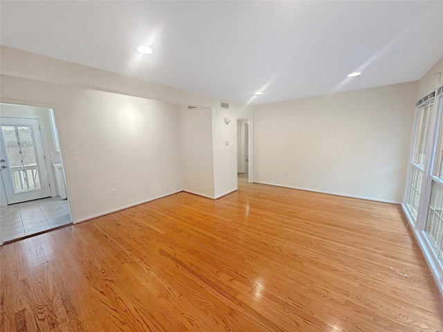 spare room with light hardwood / wood-style flooring