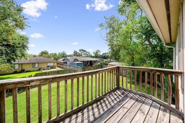 wooden terrace with a lawn