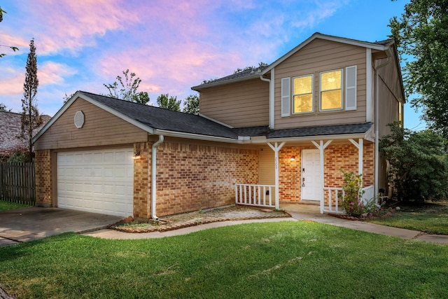 front facade featuring a garage and a lawn