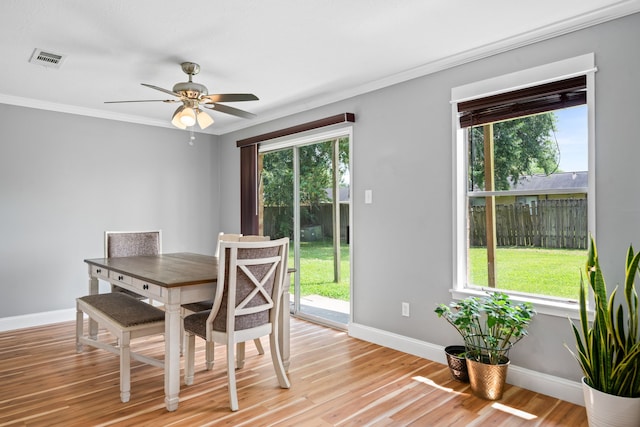 dining area featuring crown molding, light hardwood / wood-style floors, and ceiling fan