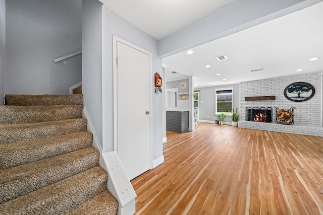 unfurnished living room with hardwood / wood-style flooring and a fireplace