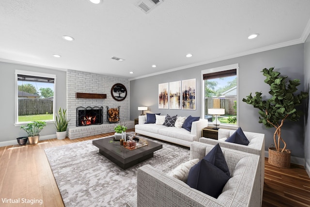 living room with ornamental molding, plenty of natural light, and hardwood / wood-style floors