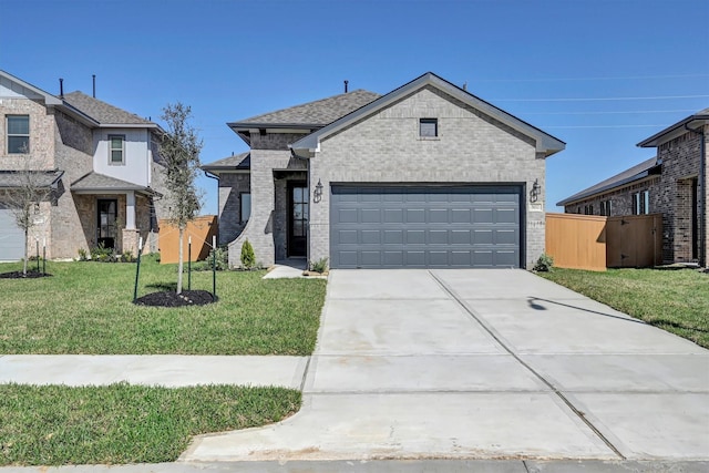 view of front facade with a garage, brick siding, concrete driveway, and a front lawn