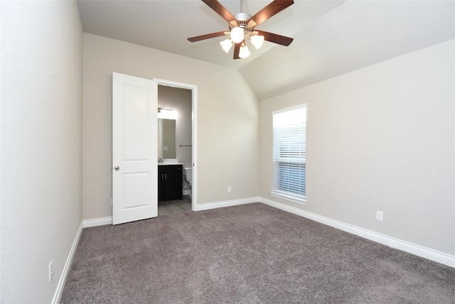 carpeted empty room with ceiling fan and lofted ceiling