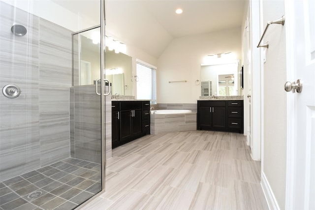 bathroom with vanity, lofted ceiling, and shower with separate bathtub