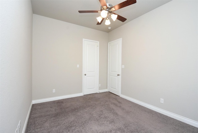 carpeted spare room featuring ceiling fan