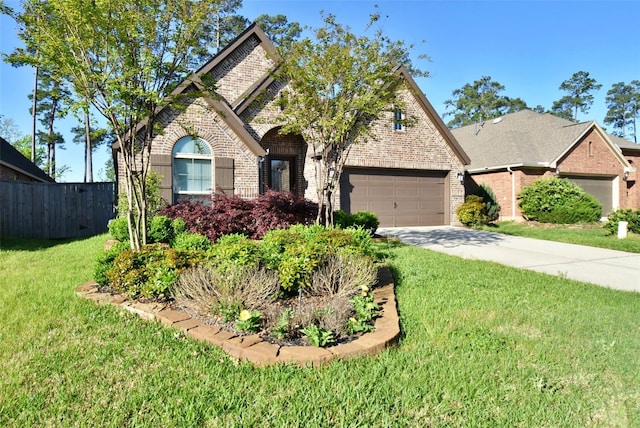 view of front of property featuring a garage and a front yard