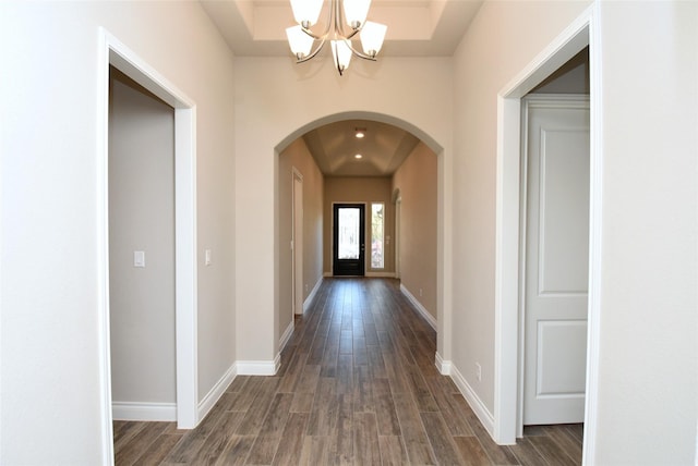 interior space with dark hardwood / wood-style flooring and a notable chandelier