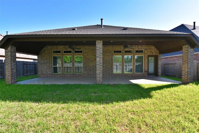 back of property featuring a patio area and a lawn