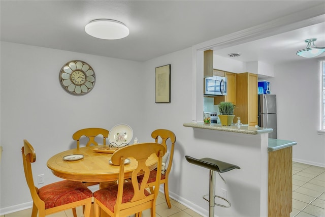 dining space featuring light tile patterned floors