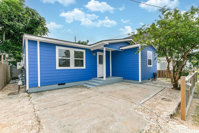 812 38th St, Galveston, TX 77550 - view of front of home with crawl space, a fenced backyard, and a patio