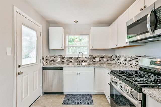 812 38th St, Galveston, TX 77550 - kitchen featuring appliances with stainless steel finishes, a sink, and white cabinetry