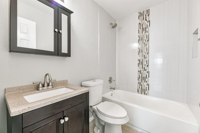 full bathroom with tiled shower / bath, vanity, and toilet