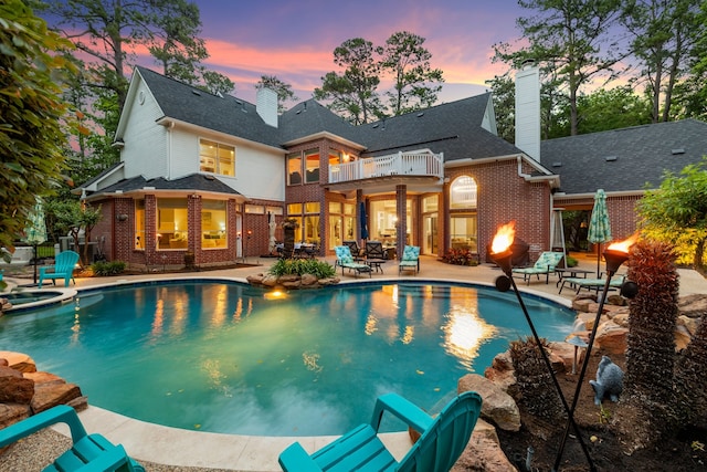 view of swimming pool featuring a patio area and a pool with connected hot tub