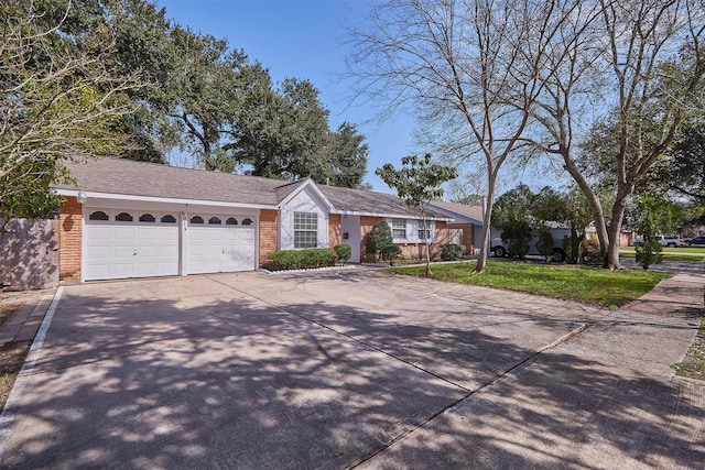 single story home featuring a garage and a front lawn