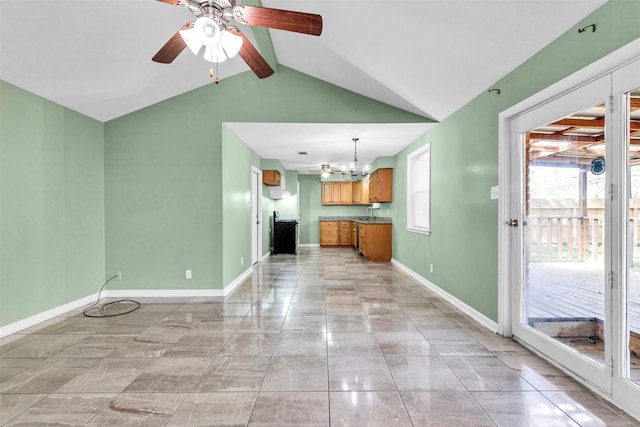 unfurnished living room with lofted ceiling with beams, a wealth of natural light, and ceiling fan