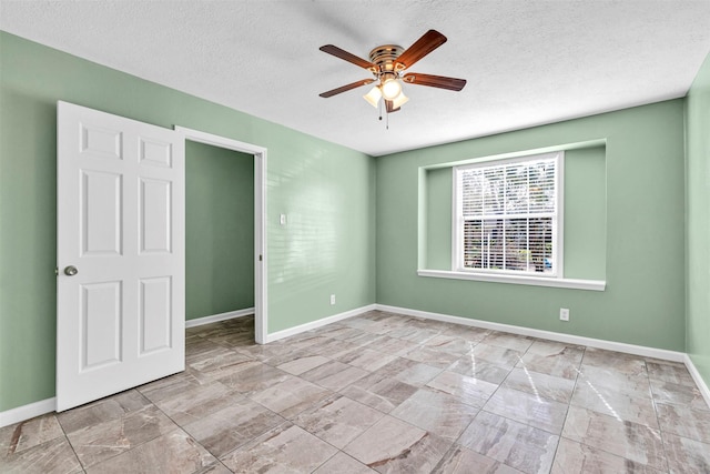 interior space with ceiling fan and a textured ceiling