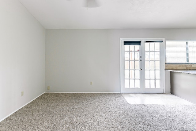 carpeted spare room with french doors