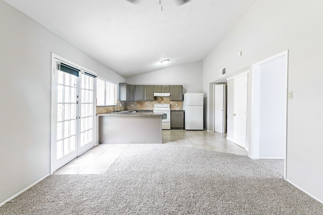 kitchen featuring sink, white appliances, decorative backsplash, vaulted ceiling, and light colored carpet