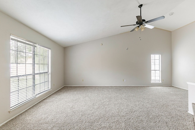 spare room featuring carpet floors, a wealth of natural light, vaulted ceiling, and ceiling fan