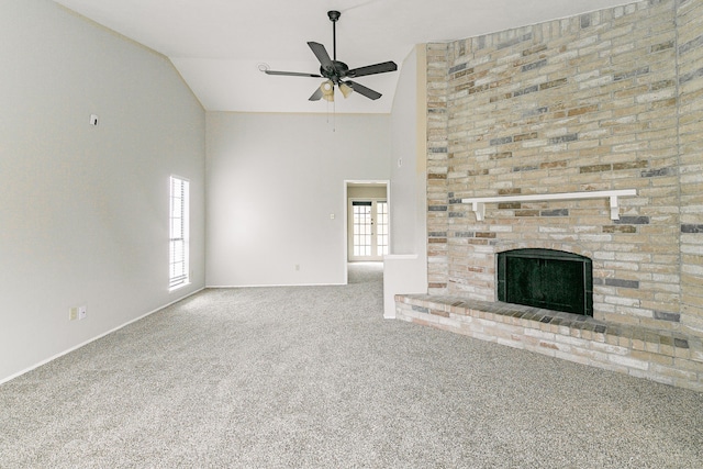 unfurnished living room with a wealth of natural light, a fireplace, high vaulted ceiling, and carpet