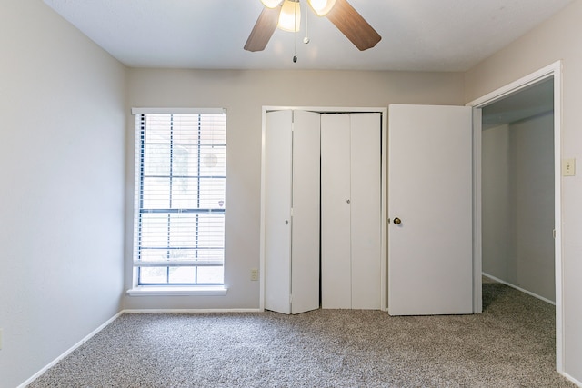 unfurnished bedroom featuring light colored carpet, ceiling fan, and a closet