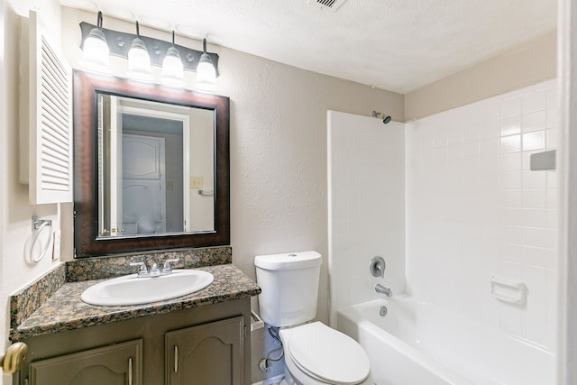 full bathroom featuring vanity, a textured ceiling, tub / shower combination, and toilet