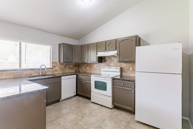 kitchen featuring lofted ceiling, sink, white appliances, and tasteful backsplash