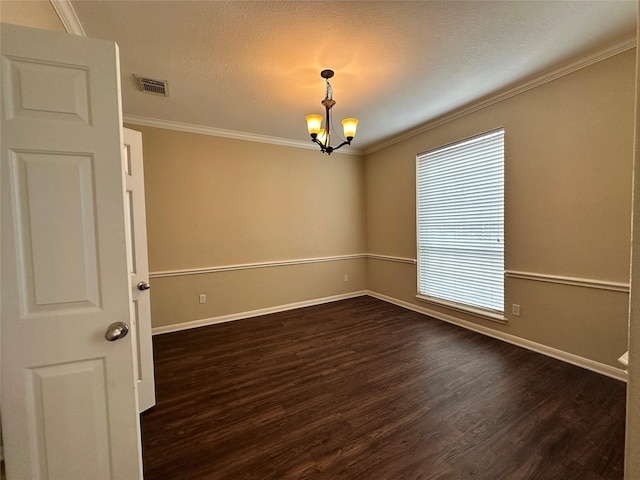 unfurnished room featuring ornamental molding, dark hardwood / wood-style floors, a chandelier, and a textured ceiling