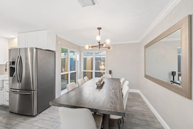 dining space featuring ornamental molding and a chandelier