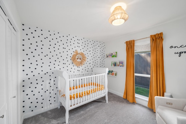 carpeted bedroom featuring multiple windows and a closet