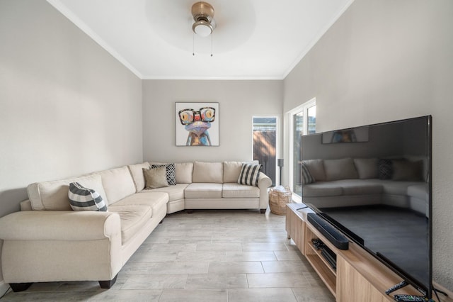 living room featuring crown molding and ceiling fan