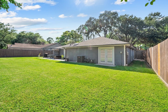 back of house featuring french doors, a patio, central AC unit, and a lawn