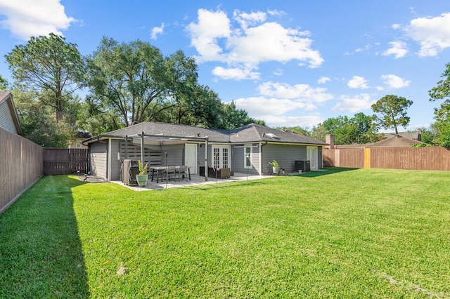 back of house featuring a patio and a lawn