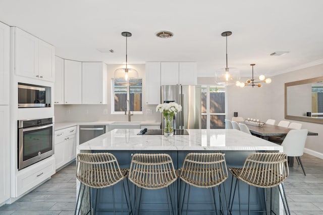 kitchen featuring a kitchen island, a breakfast bar area, and appliances with stainless steel finishes