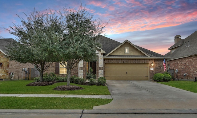 view of front of house with a yard and a garage