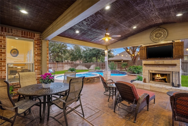 view of patio with a fenced in pool, an outdoor stone fireplace, a fenced backyard, and outdoor dining area