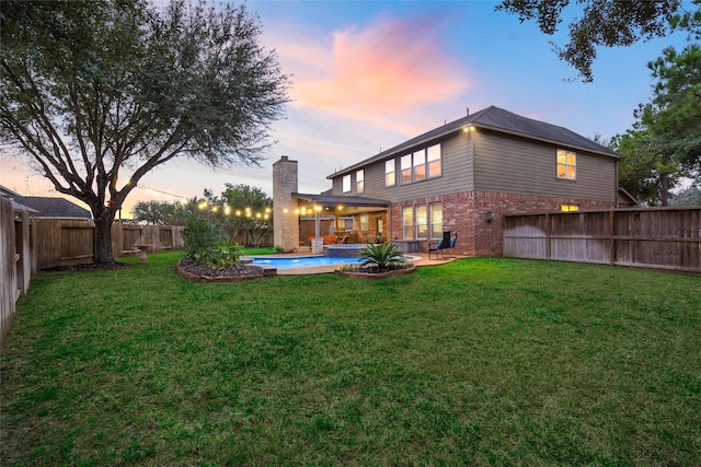 view of yard featuring a fenced in pool, a fenced backyard, and a patio