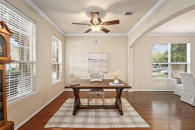 office space featuring visible vents, arched walkways, dark wood finished floors, and ornamental molding