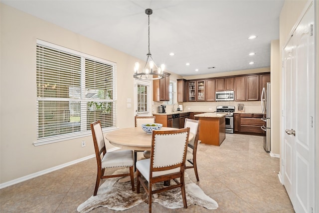 dining room featuring recessed lighting, an inviting chandelier, baseboards, and light tile patterned floors