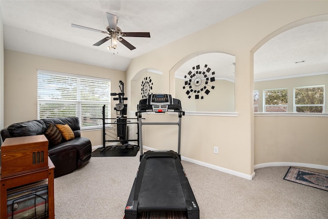 workout area featuring lofted ceiling, carpet, a ceiling fan, and baseboards