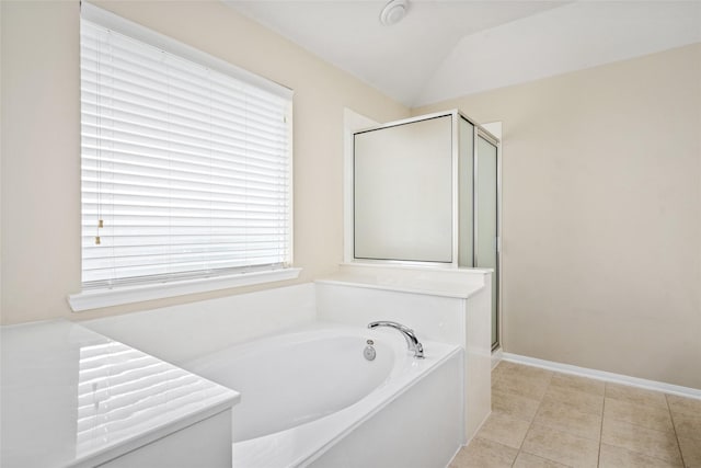 bathroom featuring baseboards, lofted ceiling, tile patterned flooring, a shower stall, and a bath