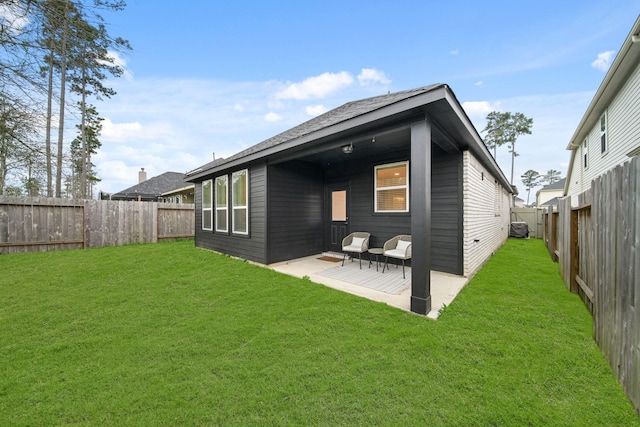 rear view of house with a lawn and a patio area