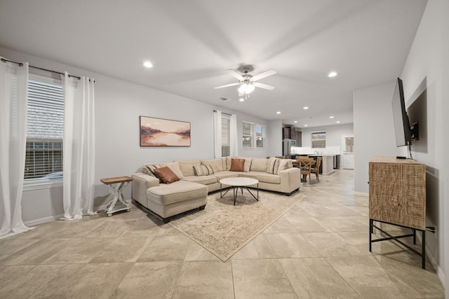 living room with ceiling fan and plenty of natural light