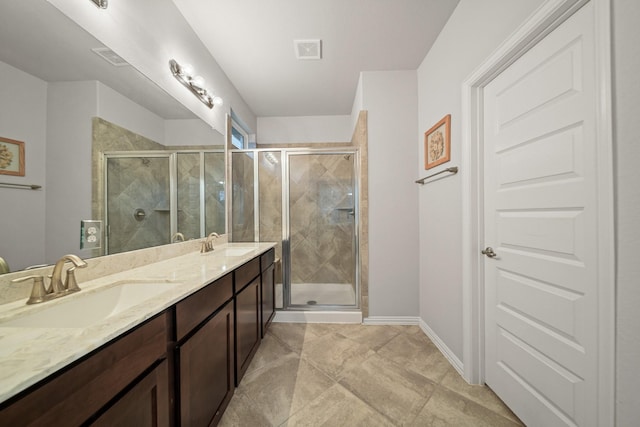 bathroom featuring a shower with door and vanity