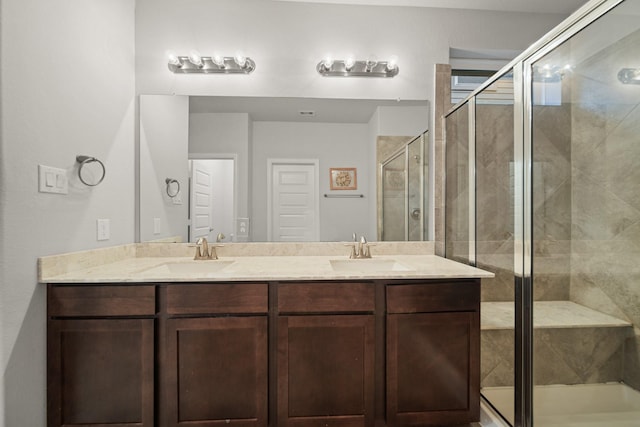 bathroom with vanity and a shower with shower door