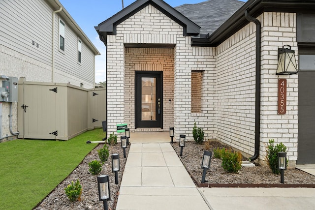 doorway to property featuring a yard