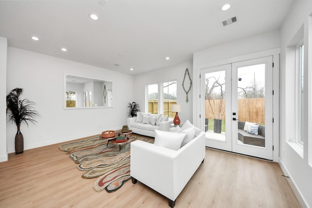 living room featuring light hardwood / wood-style floors and french doors