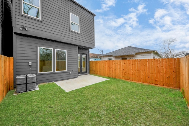 view of yard with central AC and a patio area